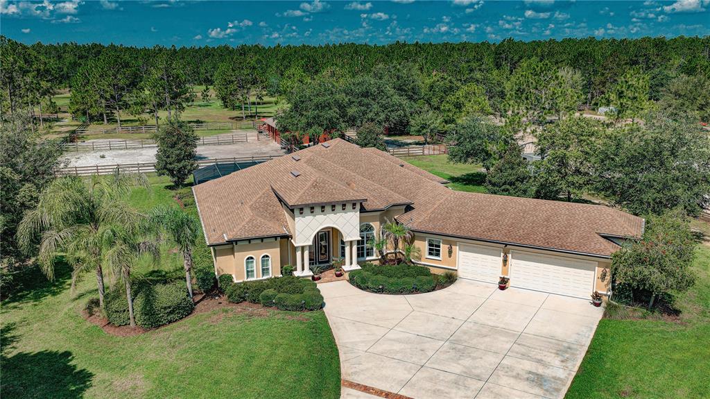 An aerial view of a single-story house with a tan roof and a concrete driveway — 4345 OLD KINGS ROAD N, PALM COAST, FL