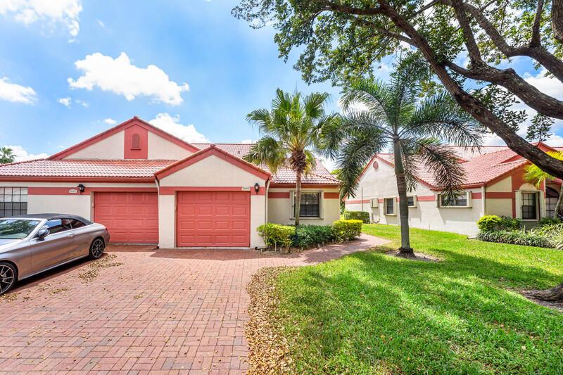 A silver convertible is parked on a brick driveway in front of a suburban house — 7888 Lexington Club Boulevard # B, Delray Beach FL 33446, DELRAY BEACH, FL