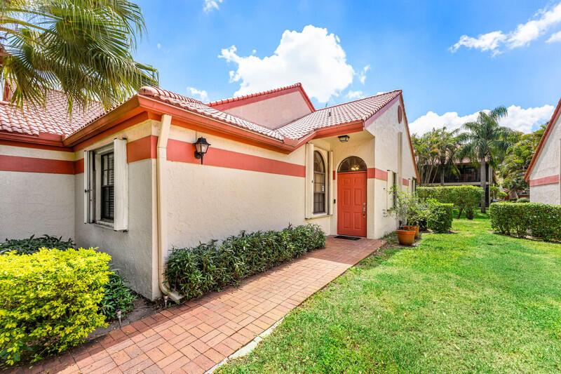 A single-story house with a red-tiled roof, orange trim, and a brick walkway — 7888 Lexington Club Boulevard # B, Delray Beach FL 33446, DELRAY BEACH, FL