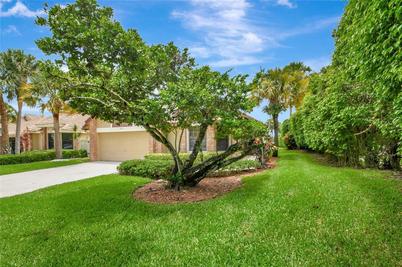 A single-story house with a tan exterior, a two-car garage, and a large front tree — 8071 Popash Court, Boynton Beach FL 33472, BOYNTON BEACH, FL