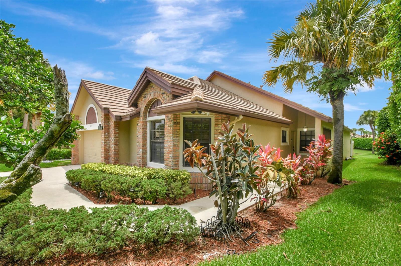 A single-story house with a brick-accented facade, tile roof, and landscaped front yard — 8071 Popash Court, Boynton Beach FL 33472, BOYNTON BEACH, FL