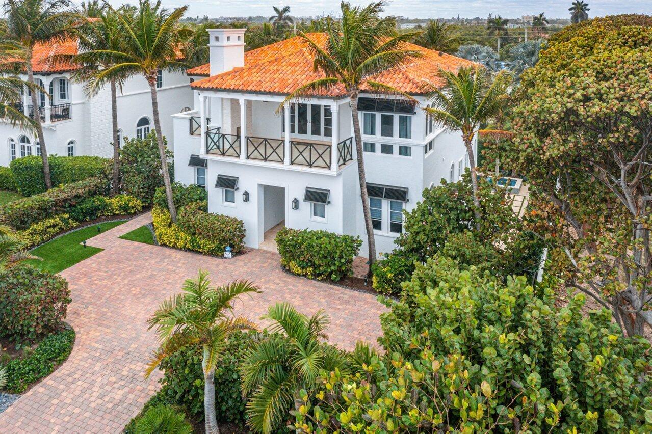 An aerial view of a white two-story house with a terracotta tile roof and driveway — 6103 N Ocean Boulevard N, Ocean Ridge FL 33435, OCEAN RIDGE, FL