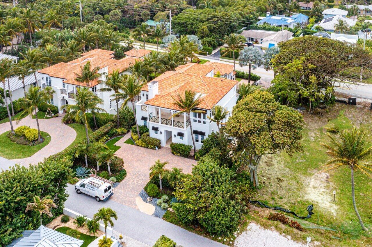 An aerial view of a white two-story house with a terracotta tile roof and driveway — 6103 N Ocean Boulevard N, Ocean Ridge FL 33435, OCEAN RIDGE, FL