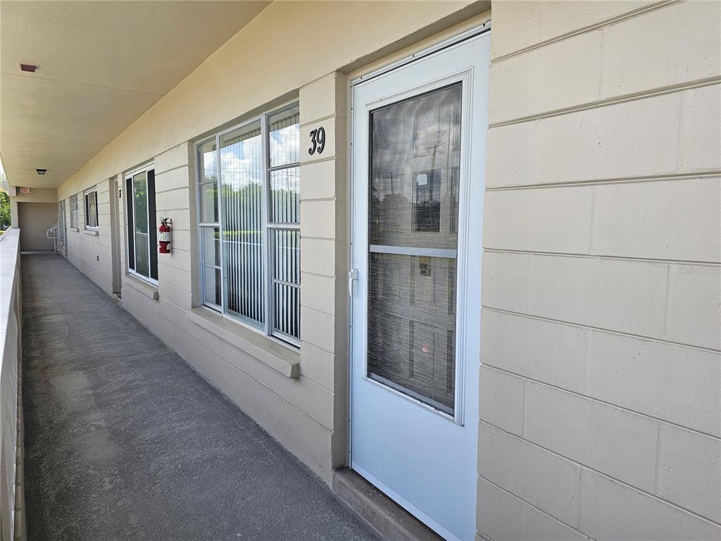 An exterior walkway leads to a white door marked with the number 39 — 2284 PHILIPPINE DRIVE UNIT 39, CLEARWATER, FL