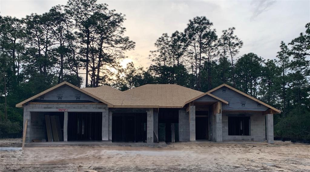 A single-story house under construction with concrete block walls and a newly installed plywood roof — 5202 N ALLAMANDRA DRIVE, BEVERLY HILLS, FL