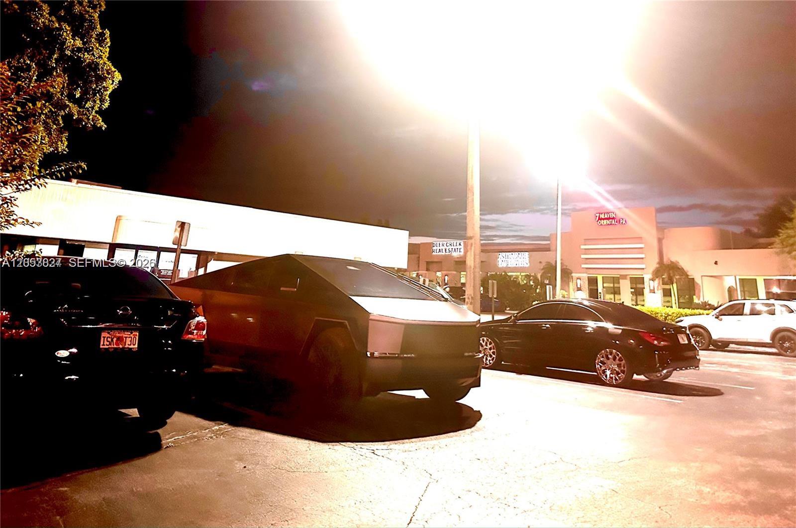 A Tesla Cybertruck is parked in a parking lot in front of a commercial building — 2215 W Hillsboro Blvd # 01, Deerfield Beach FL 33442, DEERFIELD BEACH, FL