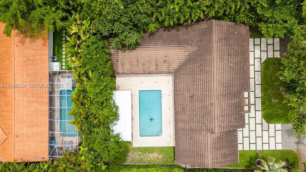 An aerial view shows a house with a brown roof, a pool, and a patio — 75 S Prospect Dr, Coral Gables FL 33133, CORAL GABLES, FL