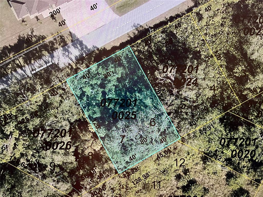 This is a satellite map view showing a highlighted rectangular plot of undeveloped land — LOT 5&6 DE MIRANDA AVENUE, NORTH PORT, FL