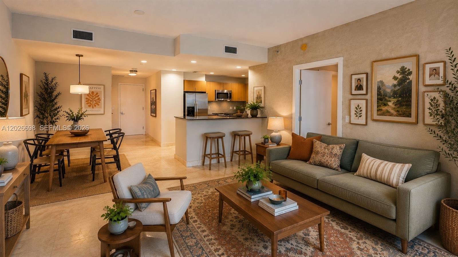 An open-concept living and dining area features a kitchen island, neutral walls, and tile flooring — 1060 Brickell Ave # 1503, Miami FL 33131, MIAMI, FL