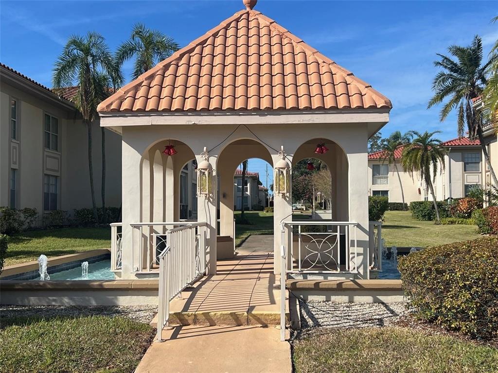 A gazebo with a tiled roof sits above a small pool in a residential courtyard — 19029 US HIGHWAY 19 N UNIT 6-14, CLEARWATER, FL