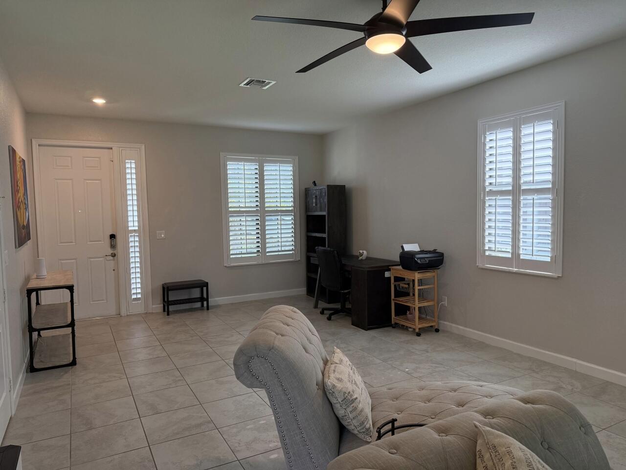 A room with tile flooring, a ceiling fan, a desk, and a tufted chaise lounge — 4426 Buena Tara Drive, FL 33413, FL