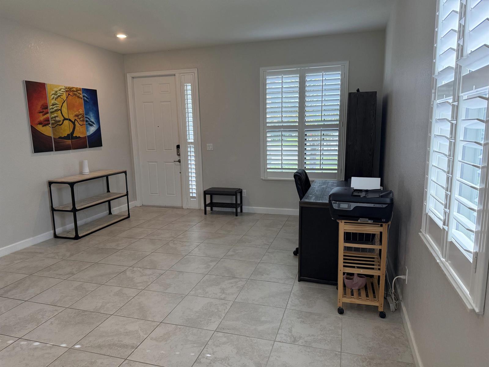 A home office with tile flooring, a desk, a printer stand, and a front door — 4426 Buena Tara Drive, FL 33413, FL