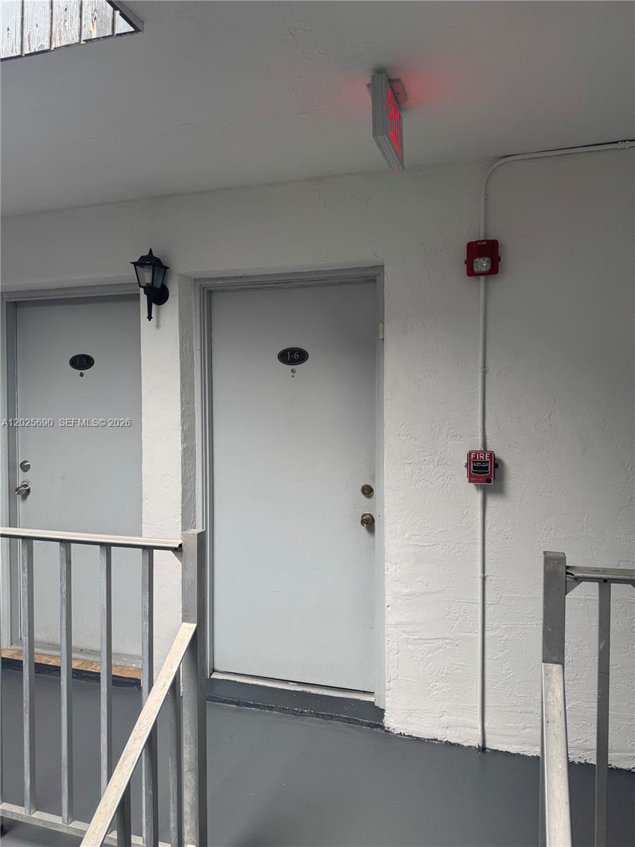 Two apartment unit doors labeled J-5 and J-6 are situated along an exterior walkway — 7235 SW 94th Pl # J6, Miami FL 33173, MIAMI, FL