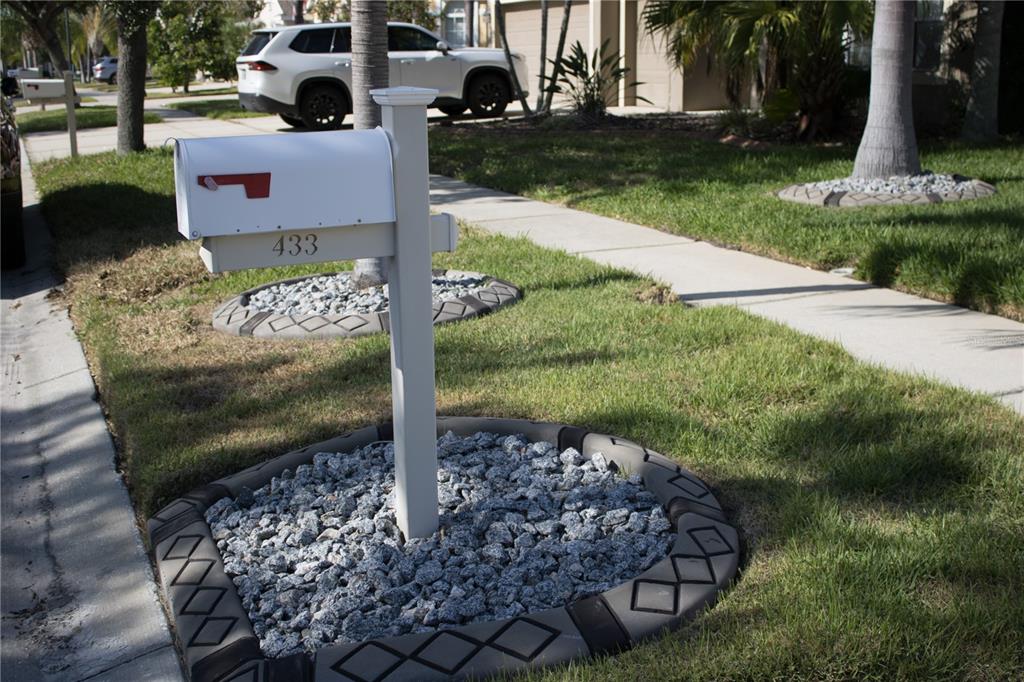 A white mailbox with the number 433 stands in a landscaped bed of gray rocks — 433 YORK DALE DRIVE, RUSKIN, FL