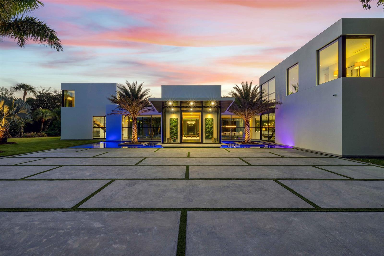 A modern white house with a large concrete paver driveway and a reflecting pool entrance — 12 N Beach Road, Jupiter Island FL 33455, JUPITER ISLAND, FL