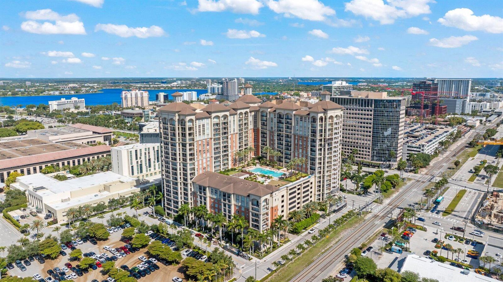 An aerial view shows a large apartment complex with a pool and surrounding city infrastructure — 550 Okeechobee Boulevard # 620, West Palm Beach FL 33401, WEST PALM BEACH, FL