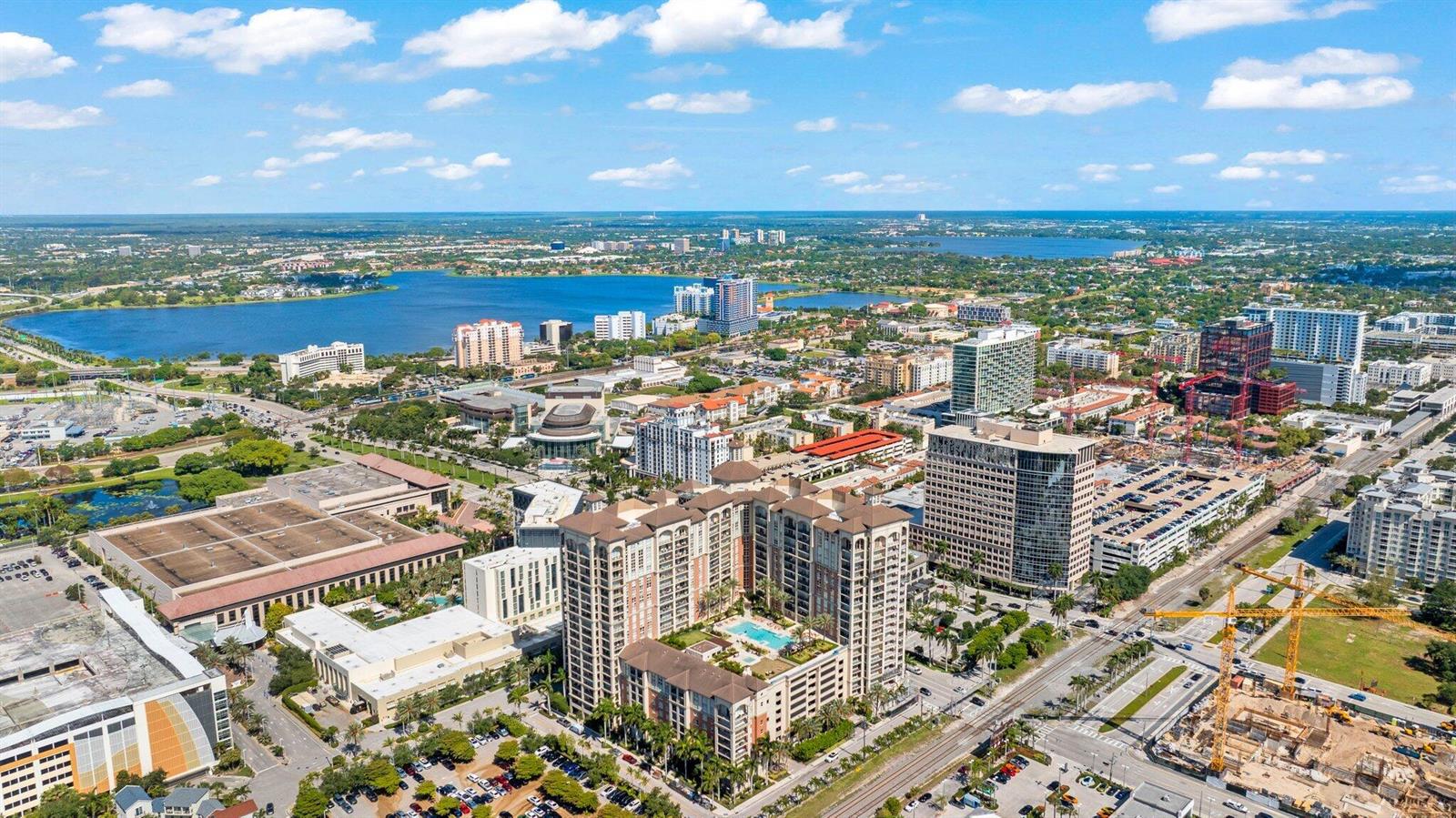 An aerial view of a city skyline with high-rise buildings, a lake, and construction sites — 550 Okeechobee Boulevard # 620, West Palm Beach FL 33401, WEST PALM BEACH, FL