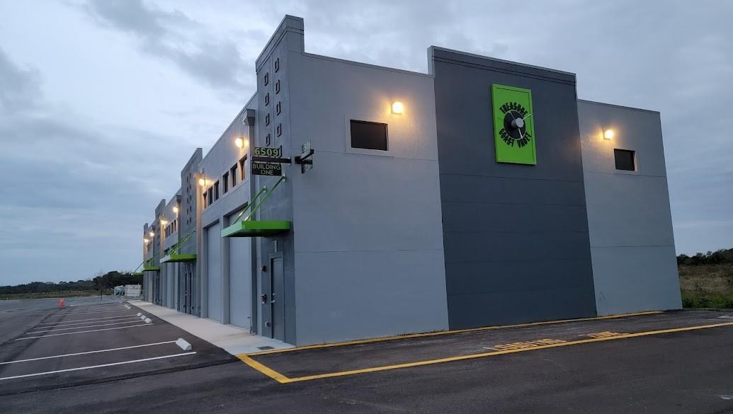 A modern, gray industrial building with green accents and a parking lot at dusk — 6509 St Lucie Boulevard # 2, Fort Pierce FL 34951, FORT PIERCE, FL