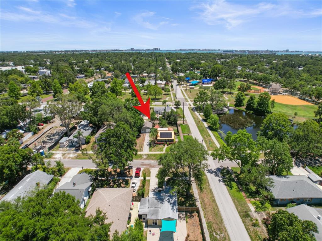 An aerial view shows a residential neighborhood with a red arrow pointing to a house — 5326 18TH AVENUE S, GULFPORT, FL