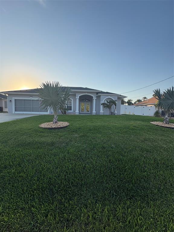 A single-story house with a garage and two palm trees in the front yard — 2927 BELLEVILLE TERRACE, NORTH PORT, FL