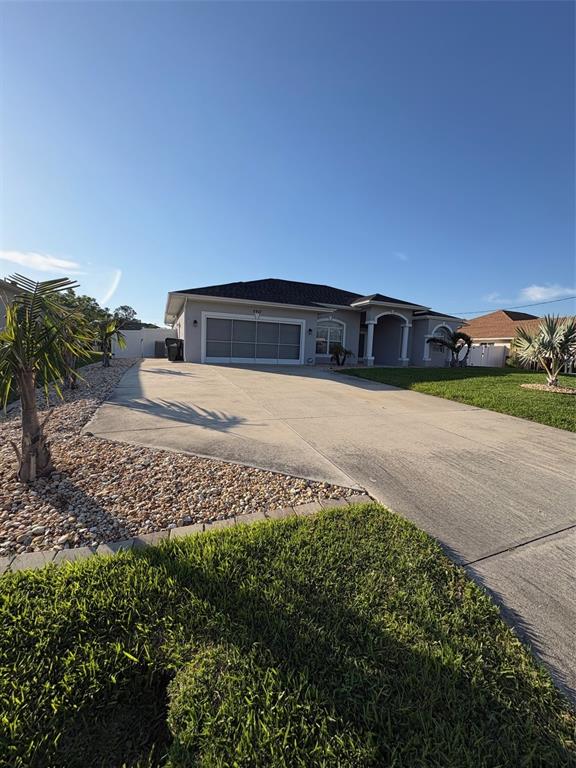 A single-story house with a large concrete driveway and a gravel landscaping bed — 2927 BELLEVILLE TERRACE, NORTH PORT, FL