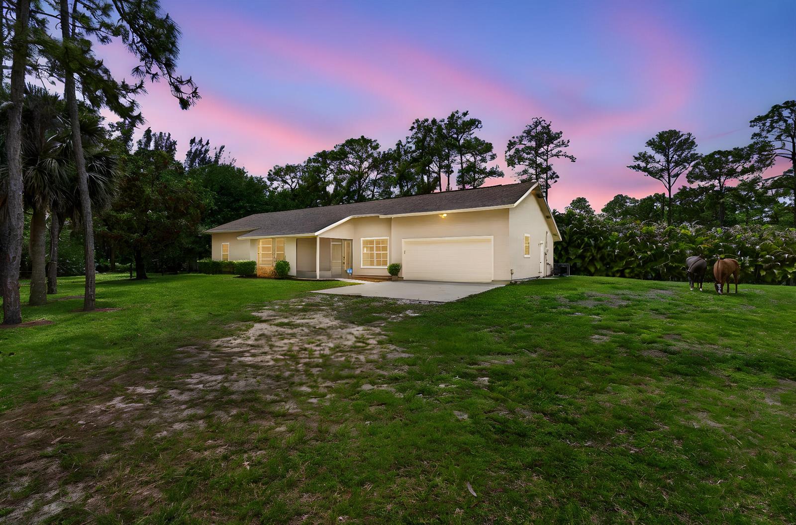 A single-story house with a garage and a large lawn featuring two horses — 6045 Hall Boulevard, FL 33470, FL