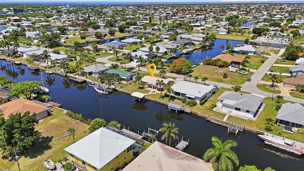 An aerial view shows a waterfront house with a yellow location pin on a canal — 4310 PALM DRIVE, PUNTA GORDA, FL
