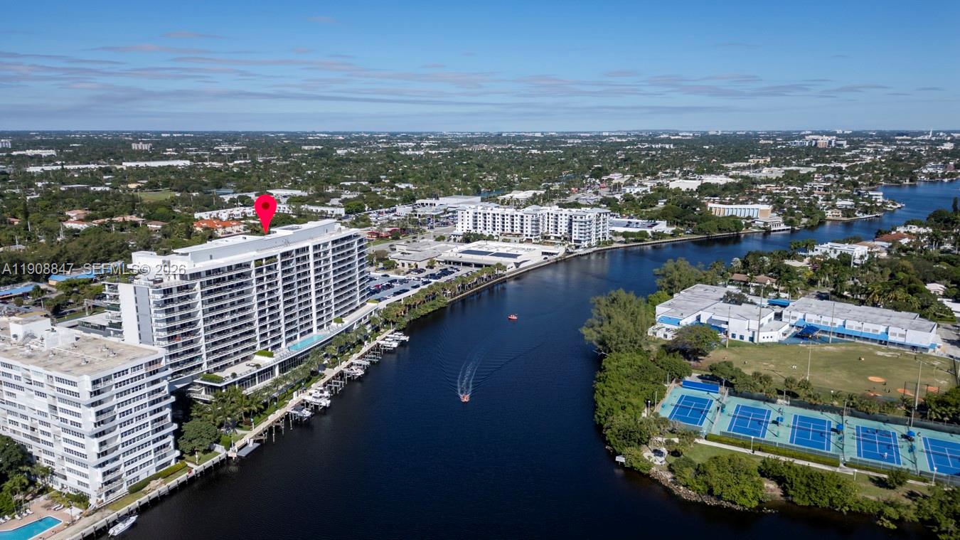 An aerial view shows a large waterfront apartment building with a red location pin — 1180 N Federal Hwy # 1602, Fort Lauderdale FL 33304, FORT LAUDERDALE, FL