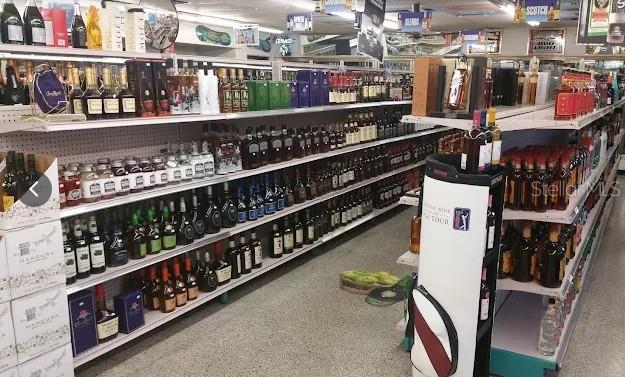 Shelves in a retail store are stocked with various bottles of liquor and wine — 503 ALT 19 HIGHWAY UNIT 503, PALM HARBOR, FL