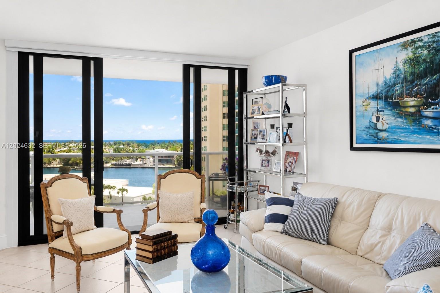 A living room features a white sofa, two armchairs, a glass coffee table, and balcony views — 20281 E Country Club Dr # 510, Aventura FL 33180, AVENTURA, FL