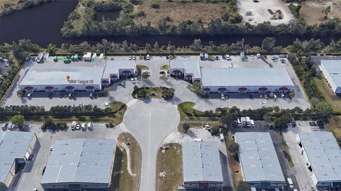 Aerial view of a commercial industrial park featuring multiple warehouse buildings and paved parking lots — 1685 Target Court, FL 33905, FL