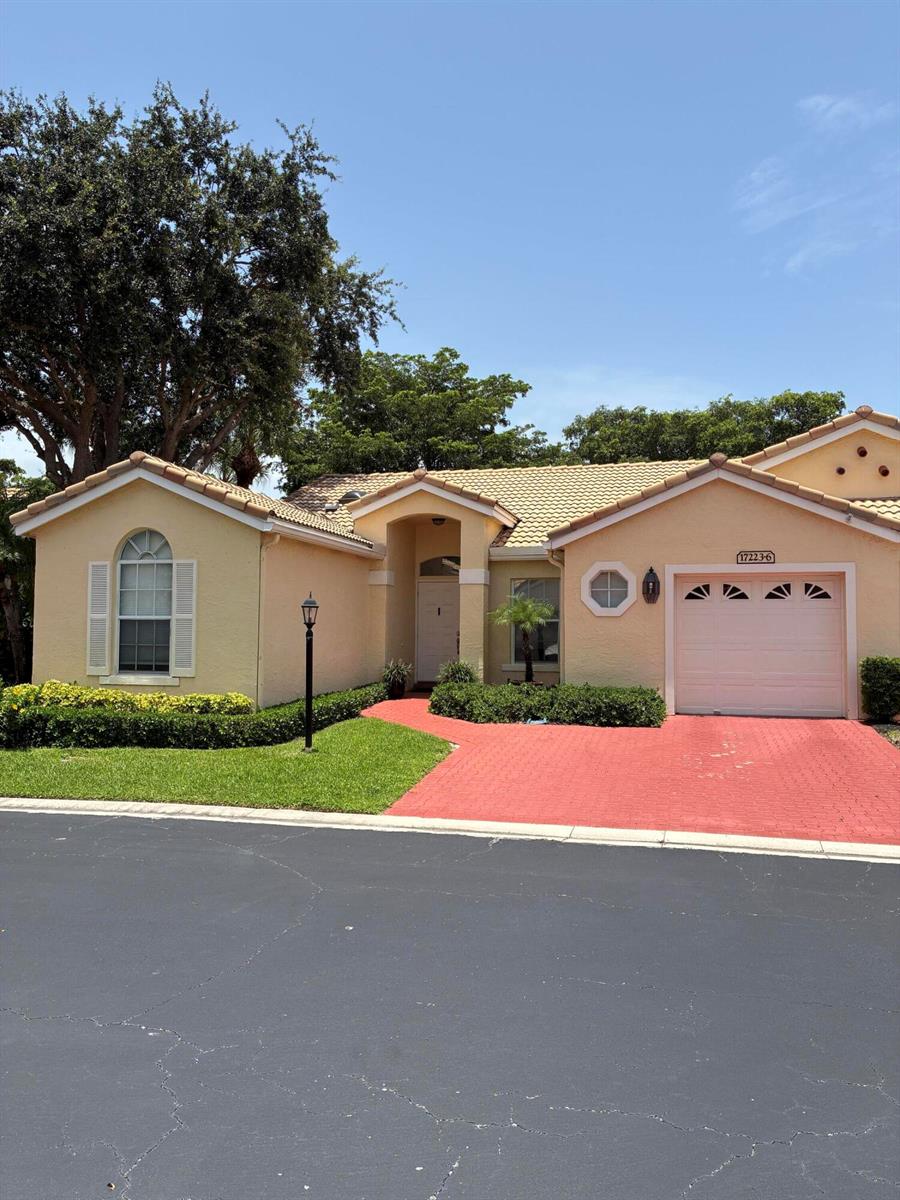 A single-story house with a tan stucco exterior, a red brick driveway, and a tile roof — 17223 Boca Club Boulevard # 6, Boca Raton FL 33487, BOCA RATON, FL