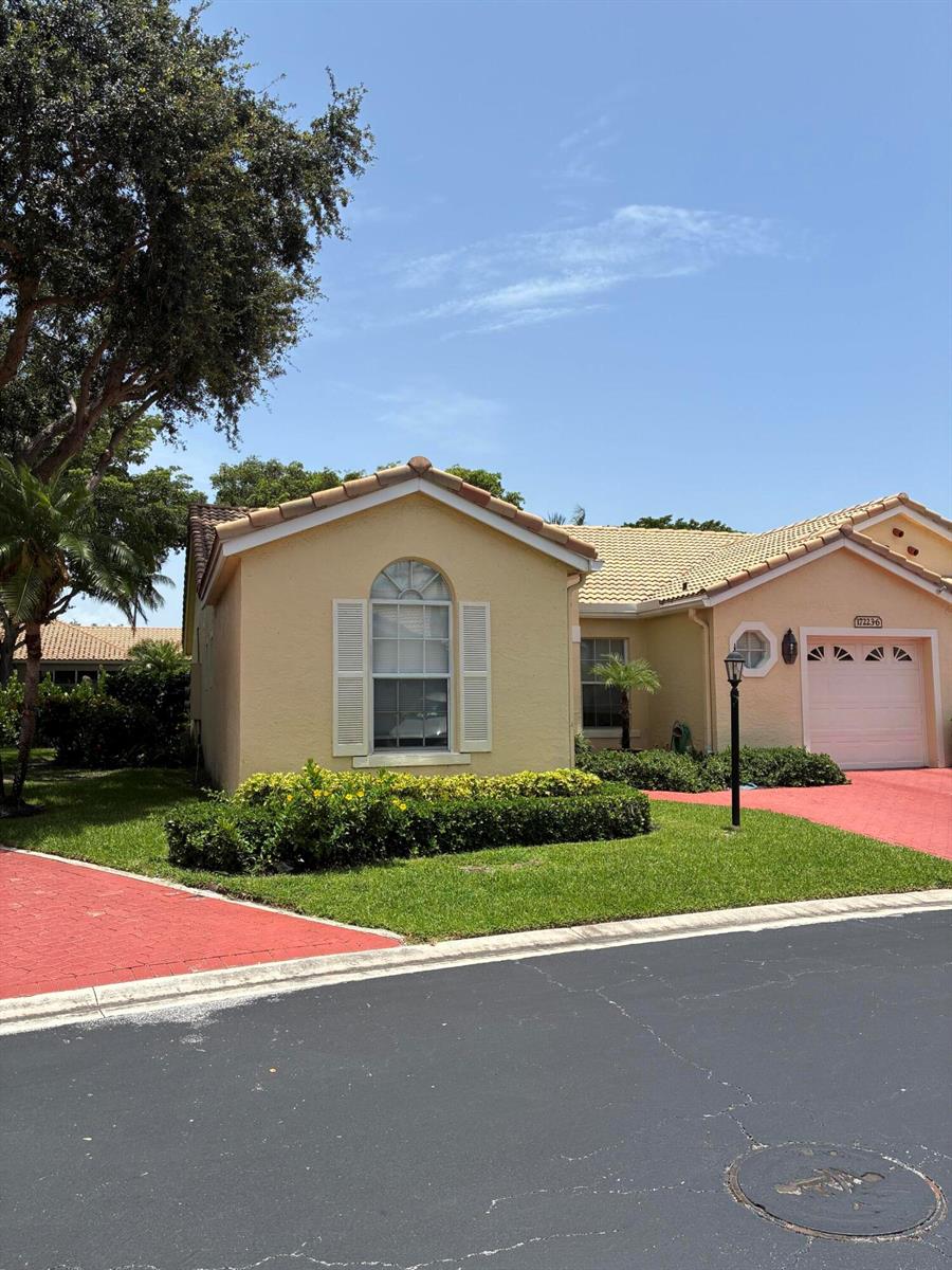 A yellow single-story house with a red paver driveway and a large tree in front — 17223 Boca Club Boulevard # 6, Boca Raton FL 33487, BOCA RATON, FL