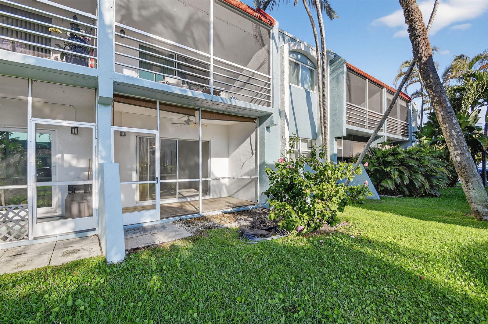 A two-story apartment building with screened-in balconies and patios overlooking a grassy lawn — 1432 S Lakeside Drive # 4, FL 33460, FL