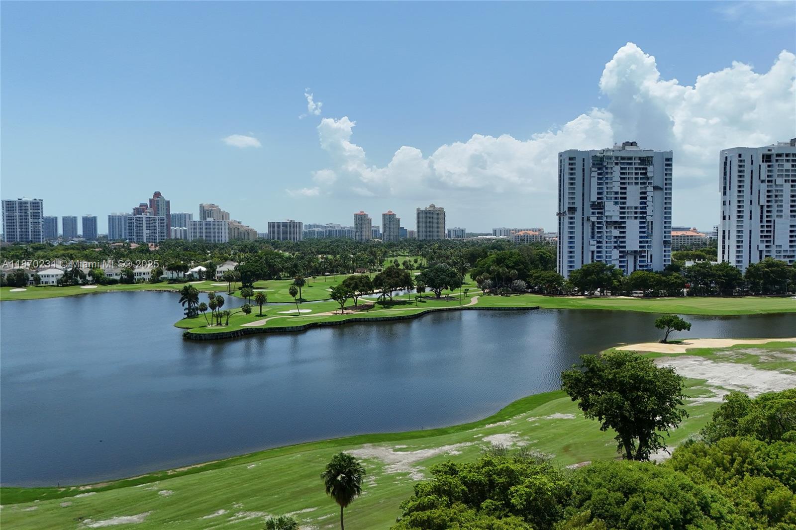 An elevated view shows a lake surrounded by a golf course and high-rise buildings — 3675 N Country Club Dr # 204, Aventura FL 33180, AVENTURA, FL