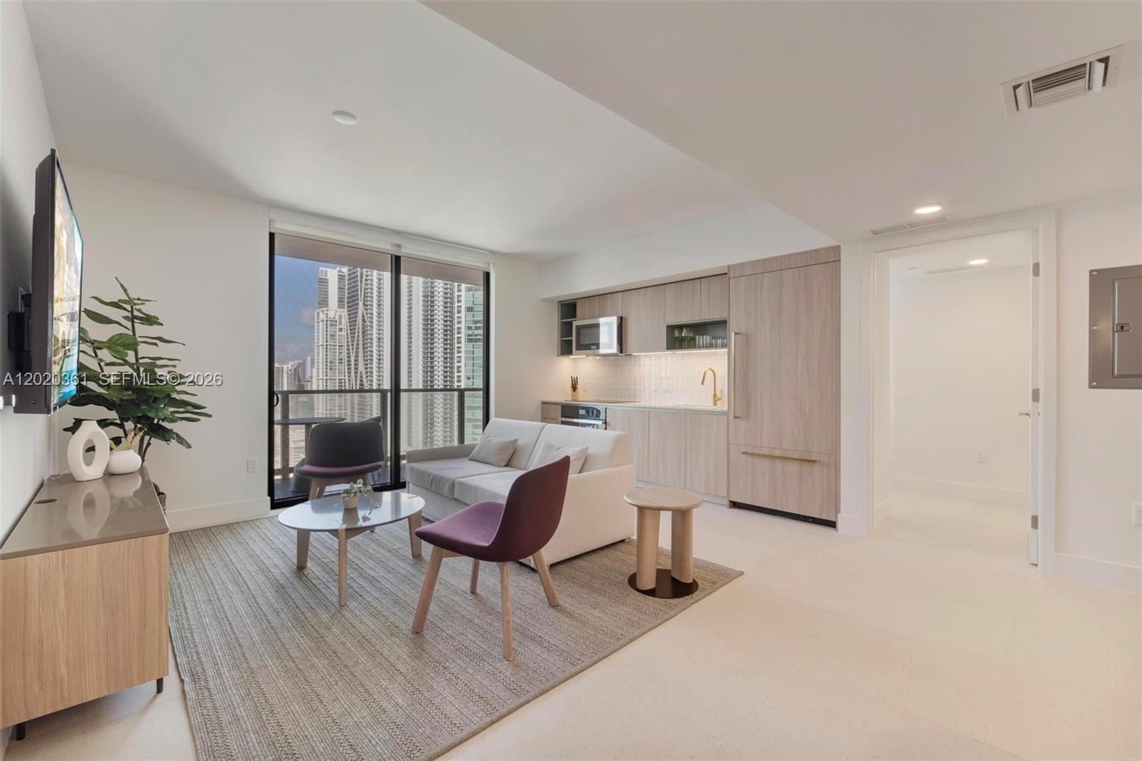 A modern studio apartment features a kitchenette, living area, and a balcony with city views — 601 ne 1st ave # 2801, Miami FL 33132, MIAMI, FL