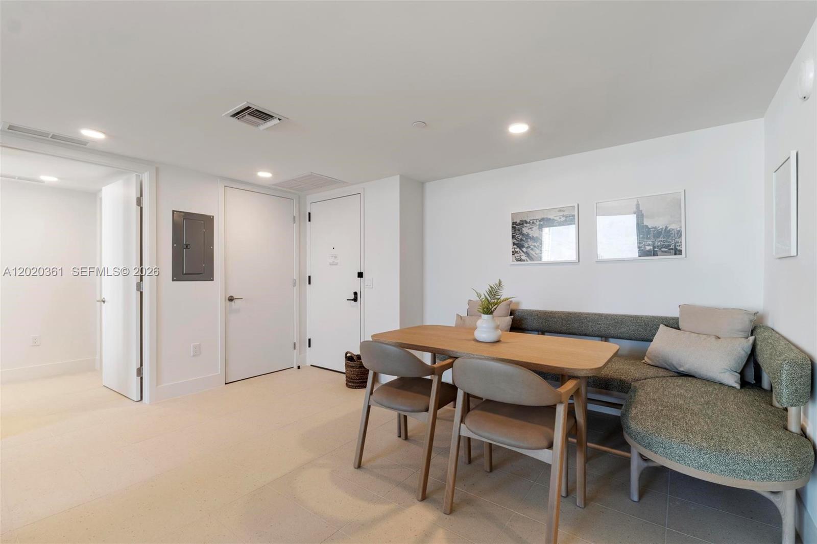 A dining area features a wooden table, two chairs, and a corner bench seat — 601 ne 1st ave # 2801, Miami FL 33132, MIAMI, FL