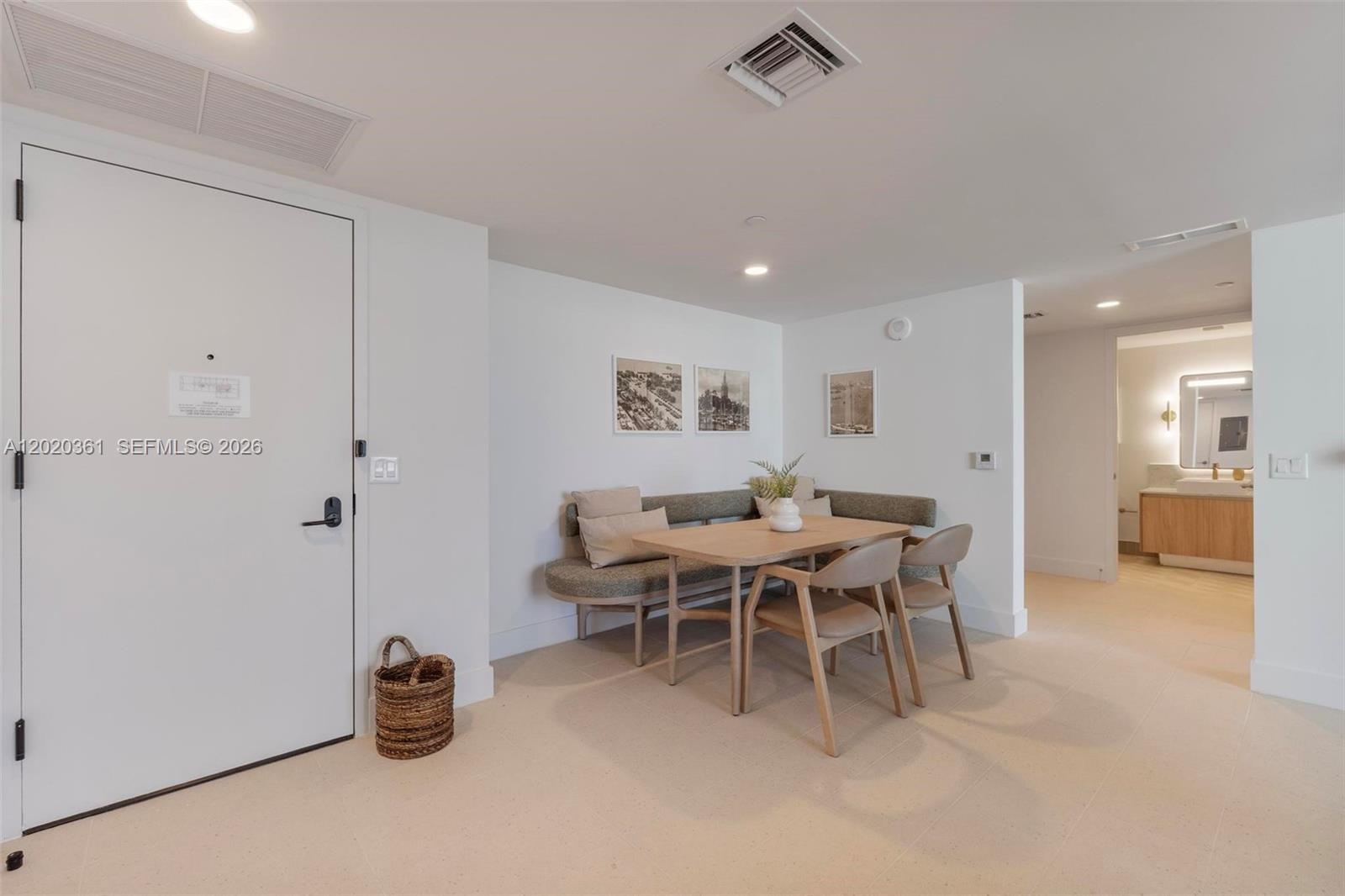 A dining area features a corner banquette, a wooden table, and two chairs — 601 ne 1st ave # 2801, Miami FL 33132, MIAMI, FL