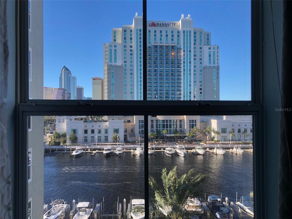 A window view overlooking a marina, a river, and the Tampa Marriott Water Street hotel — 700 S HARBOUR ISLAND BOULEVARD UNIT 523, TAMPA, FL