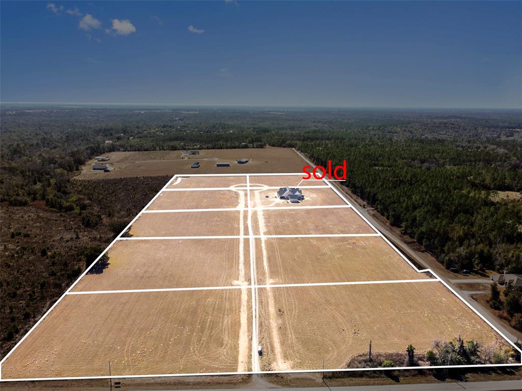 An aerial view shows a large, subdivided plot of land with one house already built — 4237 ROYAL SKY (LOT 5) COURT, BROOKSVILLE, FL