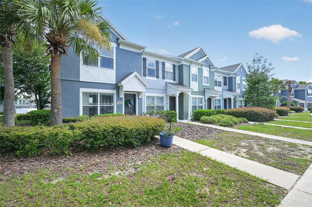 A row of two-story blue townhomes with front landscaping and a concrete walkway — 4908 SW 45TH CIRCLE, OCALA, FL