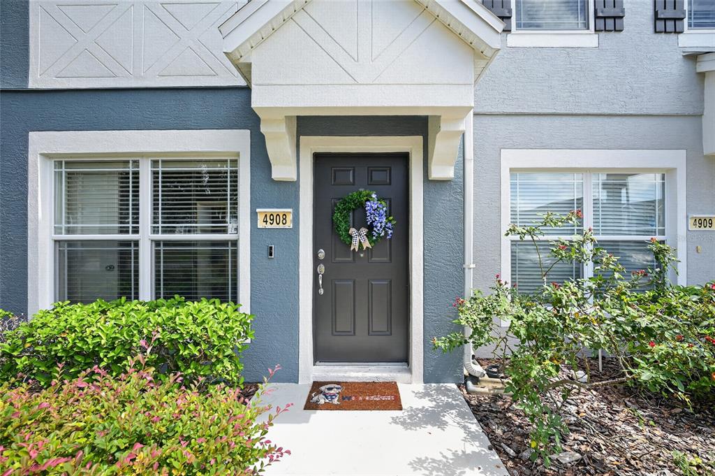 The exterior of a residential building features a dark front door with a wreath — 4908 SW 45TH CIRCLE, OCALA, FL