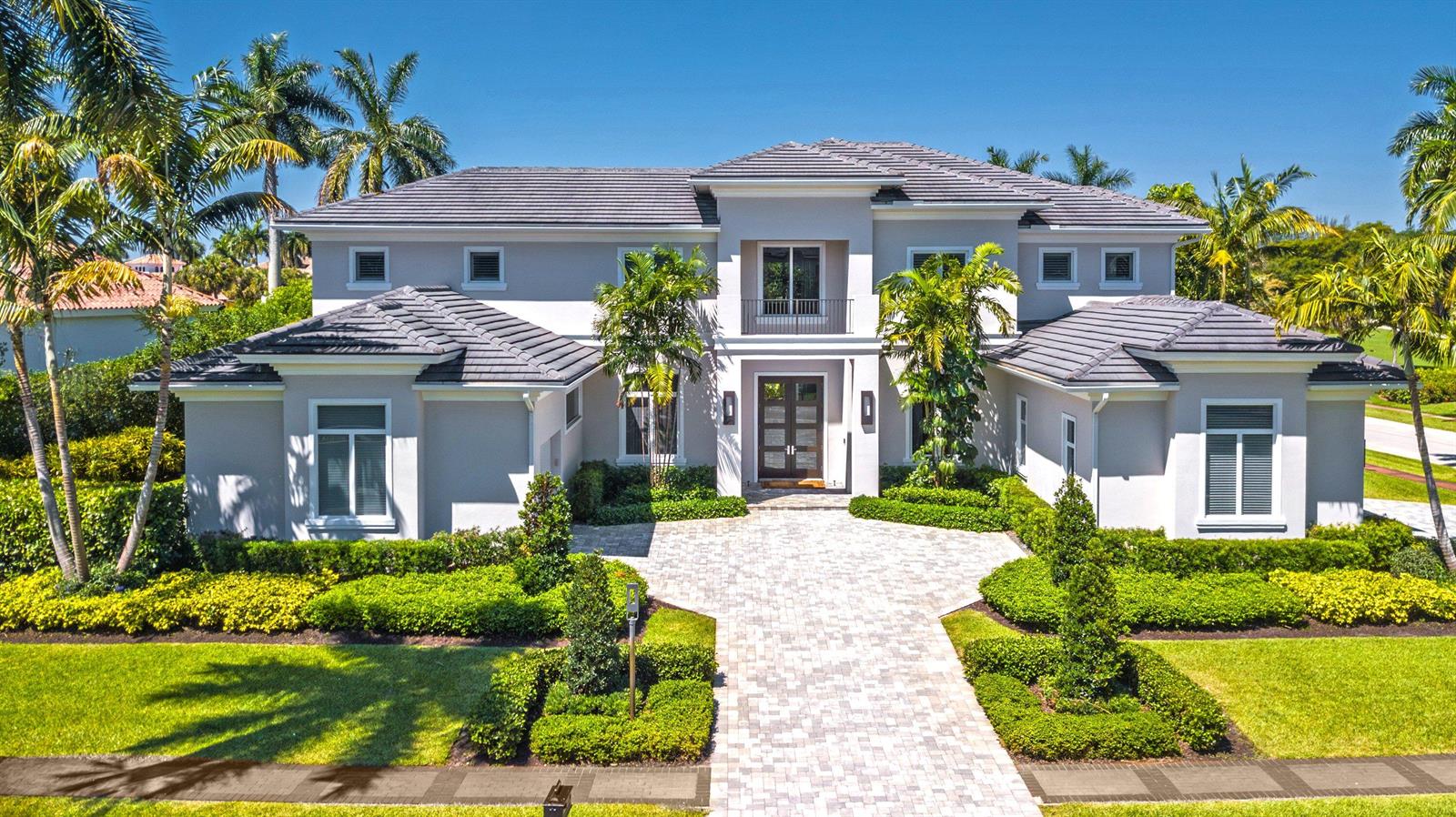 A two-story house with a gray tiled roof, light-colored stucco walls, and a paved driveway — 17661 Scarsdale Way, Boca Raton FL 33496, BOCA RATON, FL
