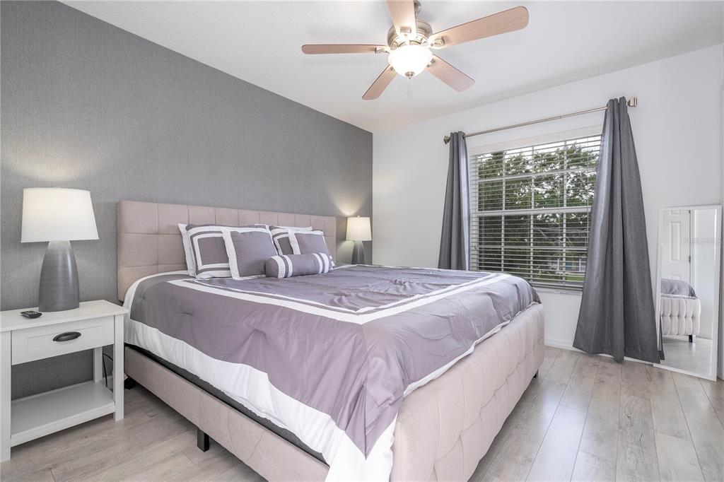 A kitchen features white cabinets, a breakfast bar with a white countertop, and tile flooring — 1120 LAS FUENTES DRIVE, KISSIMMEE, FL