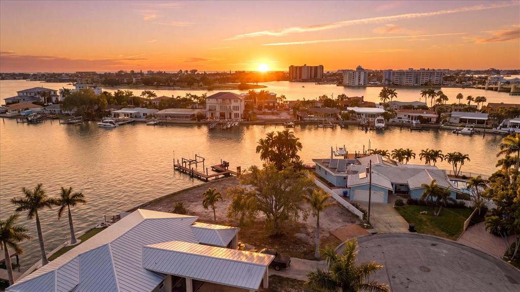 An aerial view shows a vacant waterfront lot situated between two houses on a cul-de-sac — 7998 1ST AVENUE S, ST PETERSBURG, FL