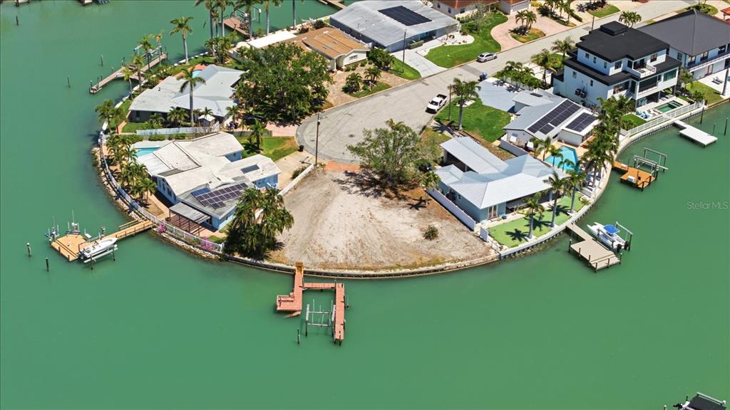 An aerial view shows a vacant waterfront lot marked with a red pin — 7998 1ST AVENUE S, ST PETERSBURG, FL
