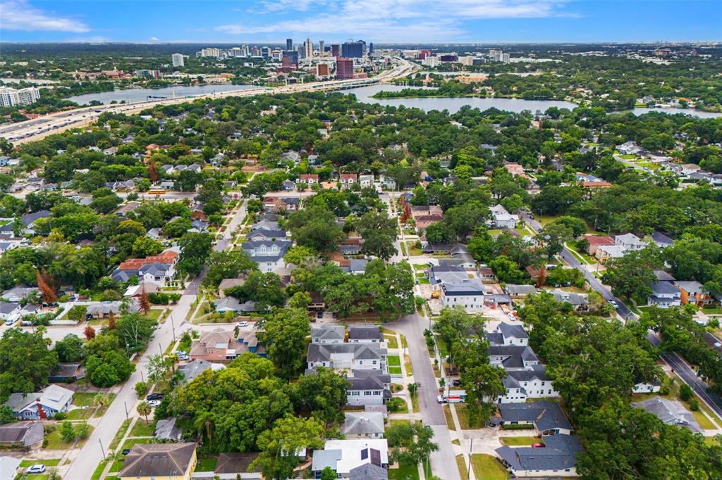 An aerial view of a residential neighborhood with a city skyline and lake in the distance — 2401 AMHERST AVENUE, ORLANDO, FL
