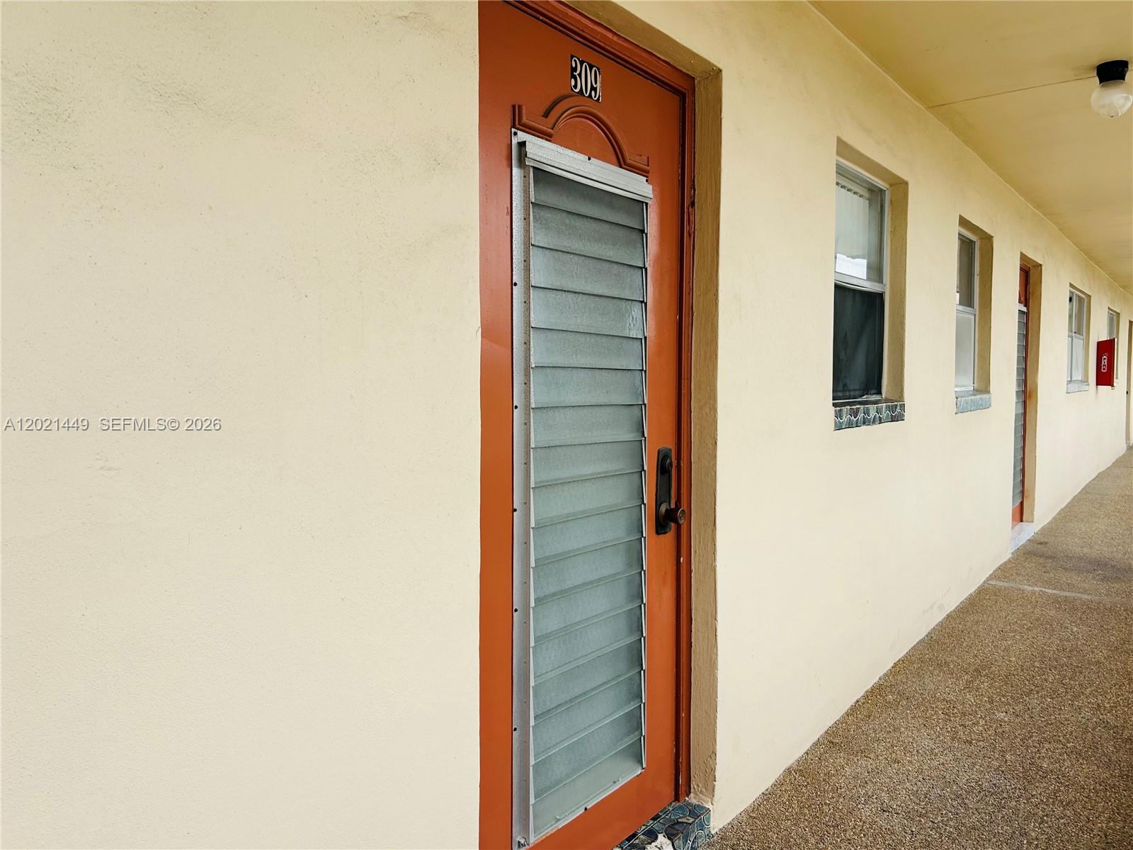An exterior view shows an orange door numbered 309 with jalousie glass panels — 2831 E Sunrise Lakes Dr # 309, Sunrise FL 33322, SUNRISE, FL