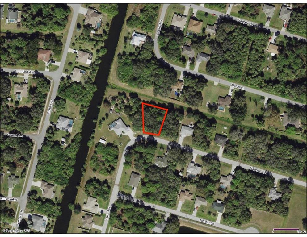 An aerial map view showing a vacant, wooded residential lot outlined in red — Lot 5 NANSEN LANE, NORTH PORT, FL