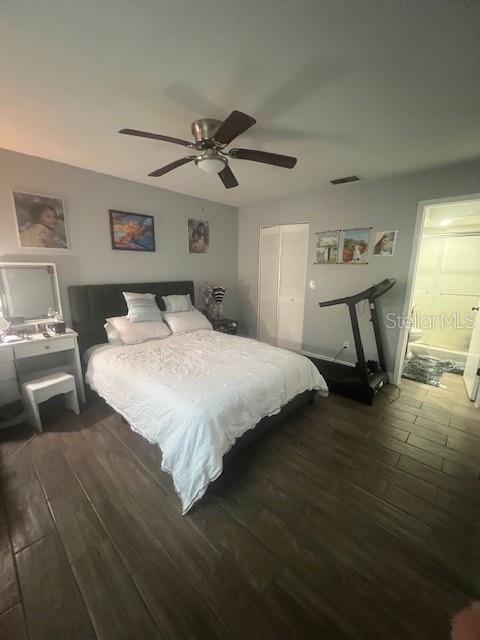 A bedroom features a bed, a vanity, a treadmill, and tile flooring — 4016 LAKE BOULEVARD, CLEARWATER, FL